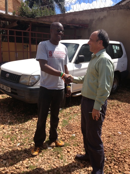 Eric shakes hands with Jack, the Uganda Country Director at CRS.